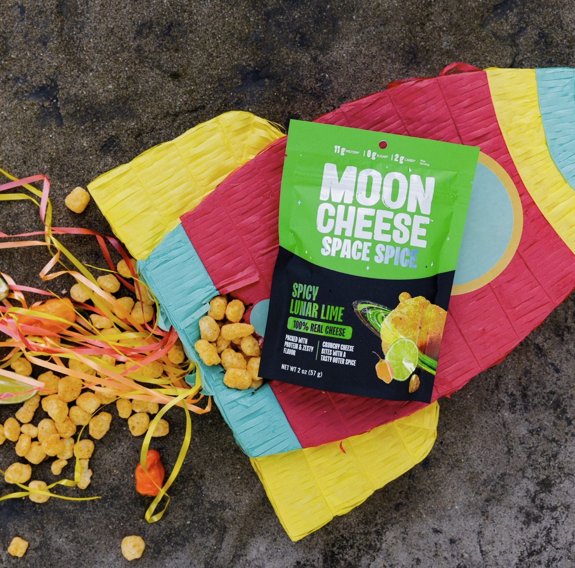 Moon Cheese Space Spice Lunar Lime packaging with colorful pinata styling and scattered cheese bites